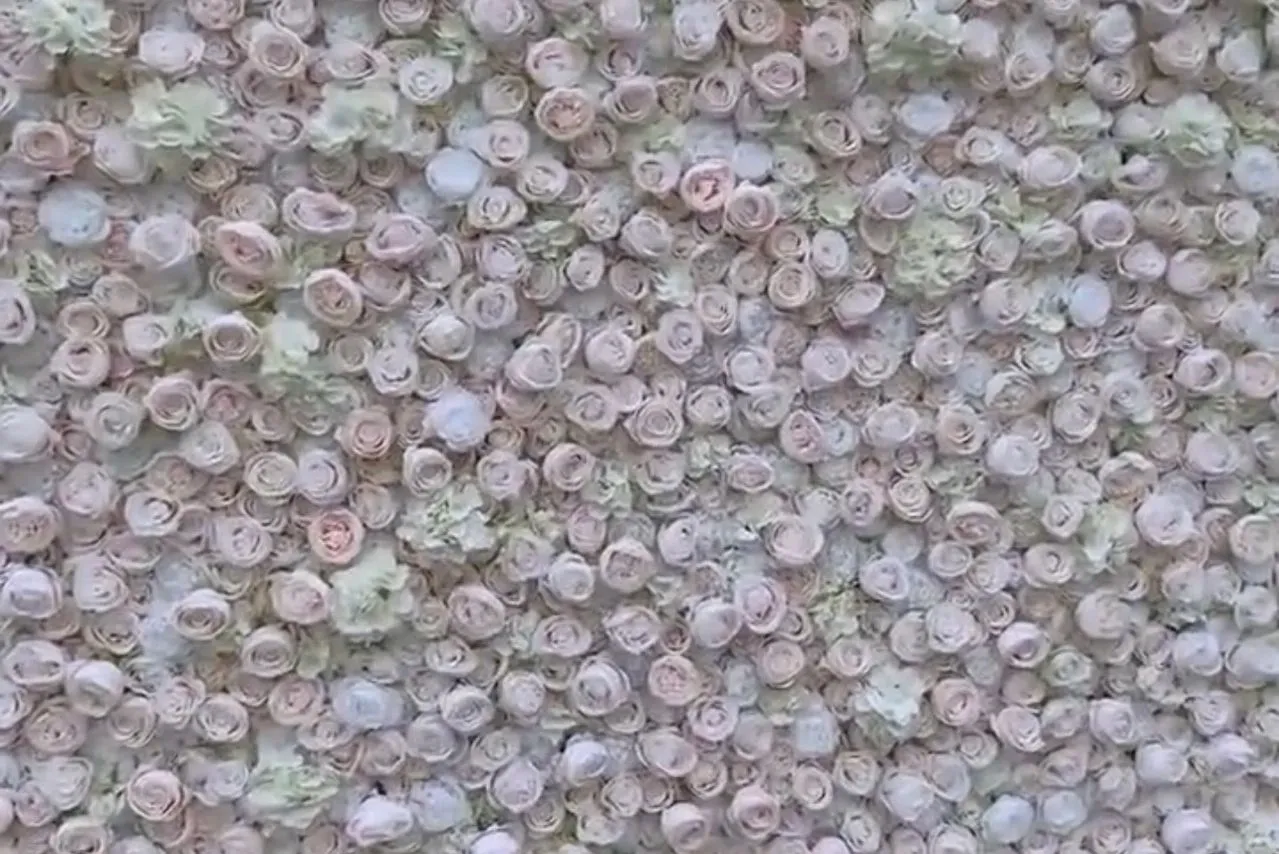 A close up of the top of a wall covered in flowers.